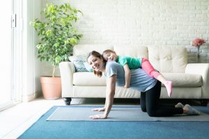 woman-working-out-at-home-with-daughter