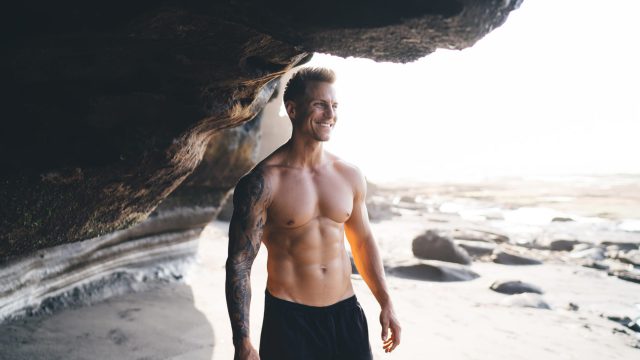 Happy,Young,Shirtless,Male,Model,In,Black,Shorts,With,Muscular